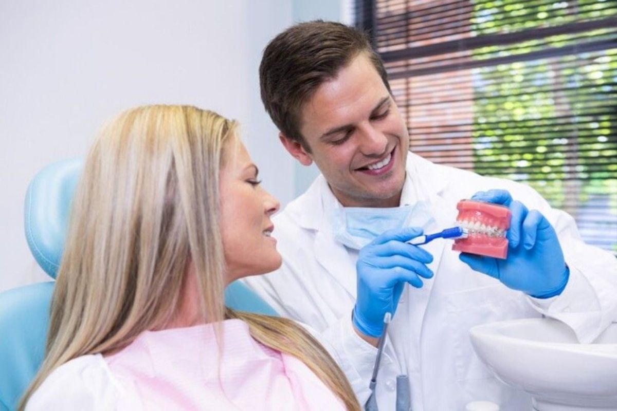 dentist explaining dental implant treatment options to a patient during consultation